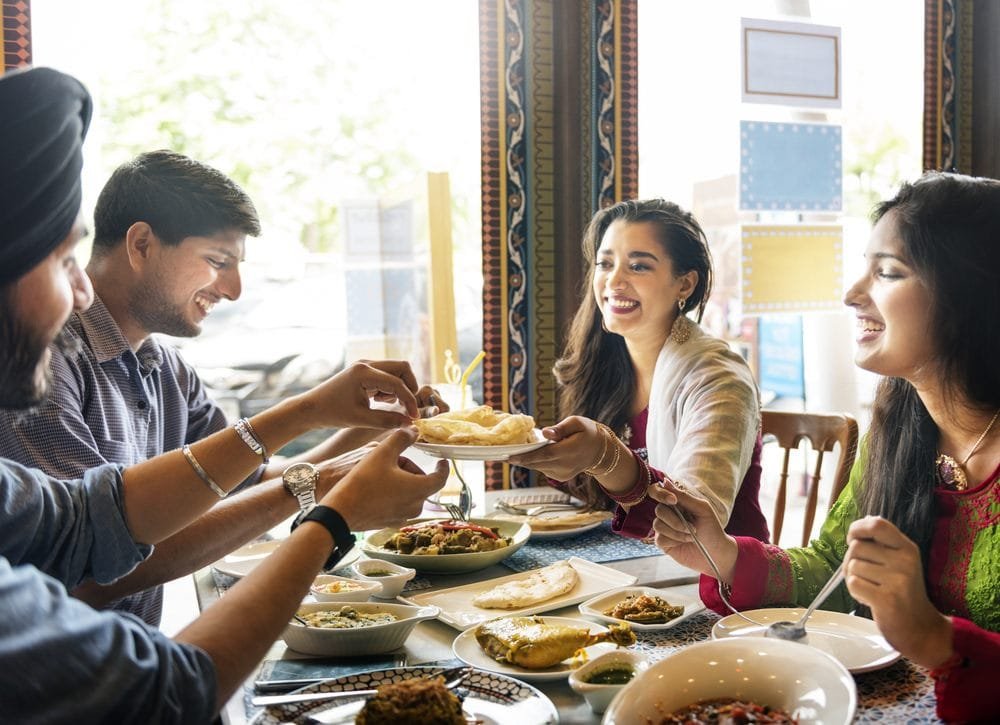 Why Swad is the Premier Indian Restaurant in West Vancouver. Indian Food Eating Cuisine Togetherness Concept.